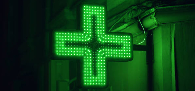 Green-Colour-Cross-Sign-of-Late-Night-Pharmacy-Chemist-Glowing-in-Night