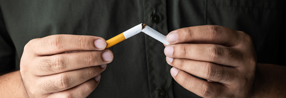 Man-Holding-a-Broken-Cigarette-after-Quitting-Smoking