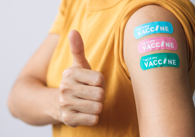 A-Woman-Showing-Thumbs-Up-Sign-After-Receiving-Vaccine
